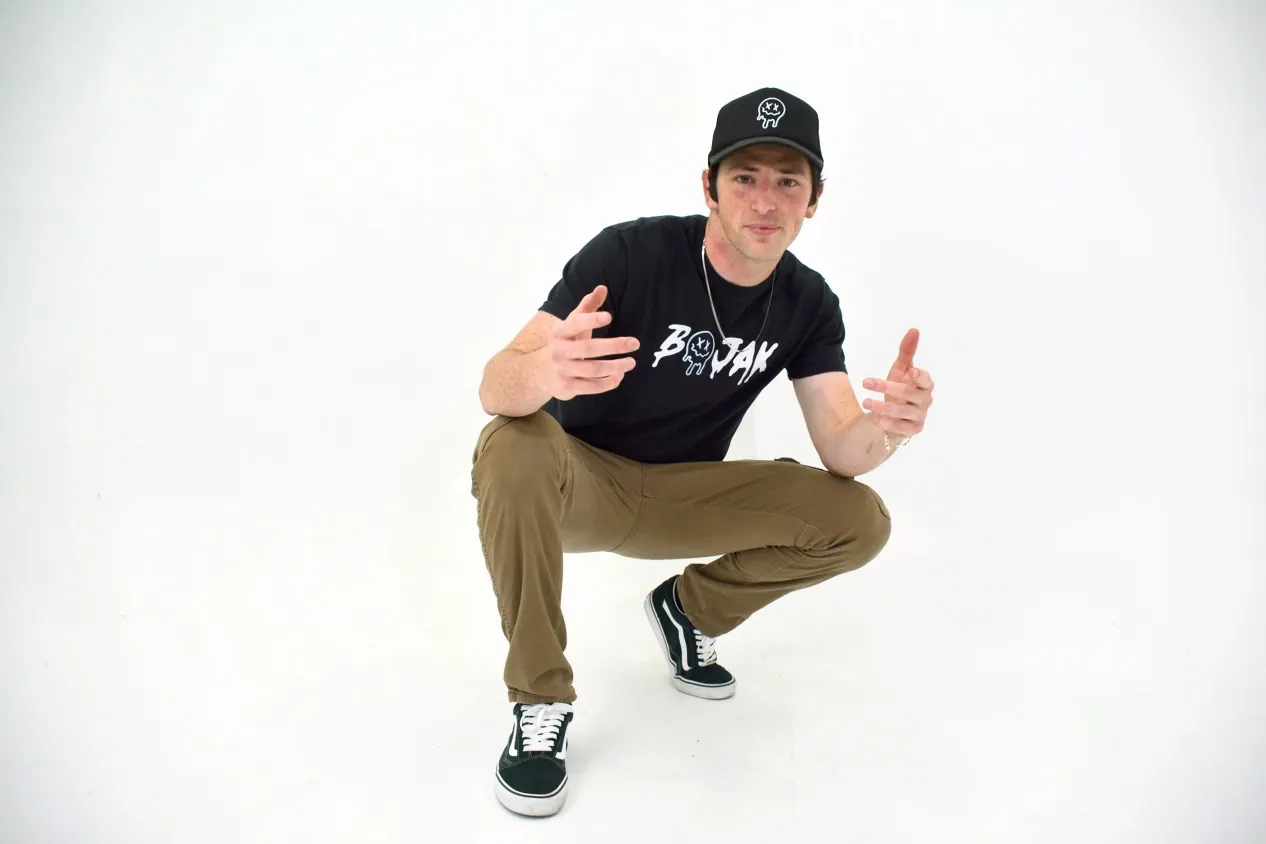 BOJAK in a white studio wearing BOJAK apparel