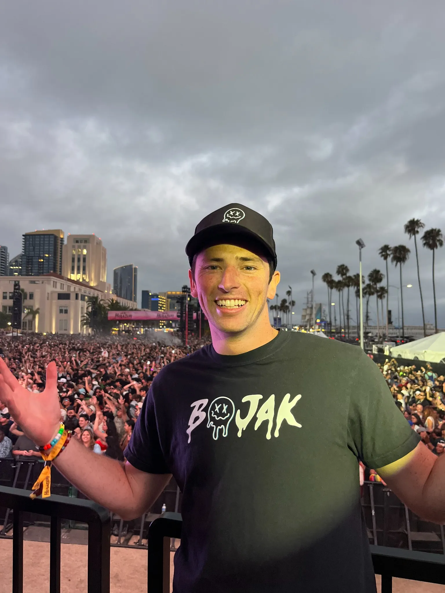 BOJAK smiling in front of a large outdoor festival crowd in San Diego