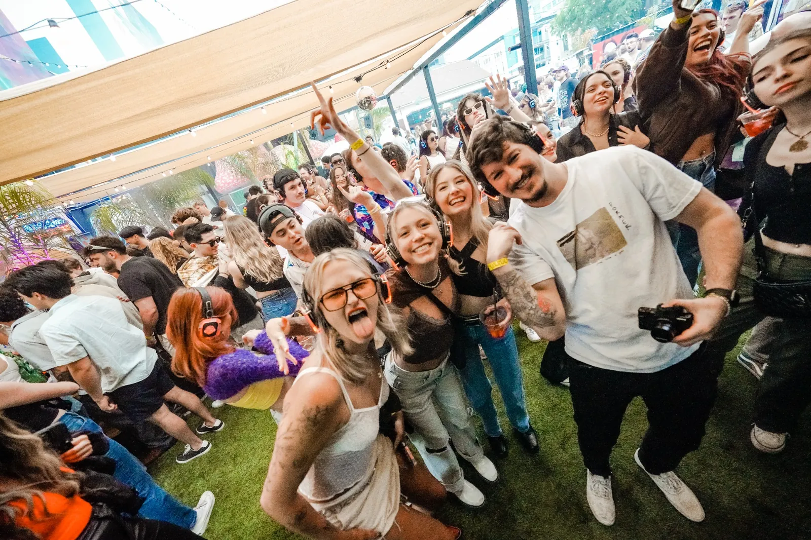 Crowd smiling and dancing together