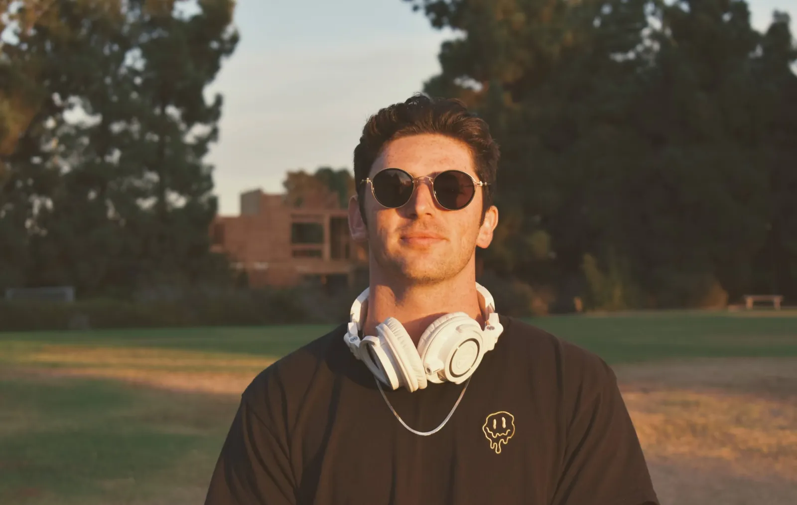 BOJAK outdoors at golden hour with headphones